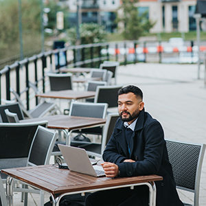 Man working remotely outside on his laptop